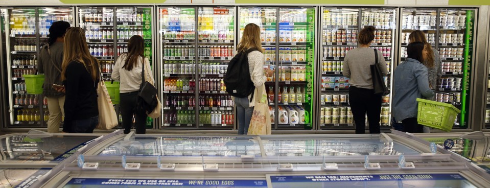 Customers shop in the dairy section of the 365 by Whole Foods Market store in the Silver Lake neighborhood of Los Angeles, on May 25, 2016.